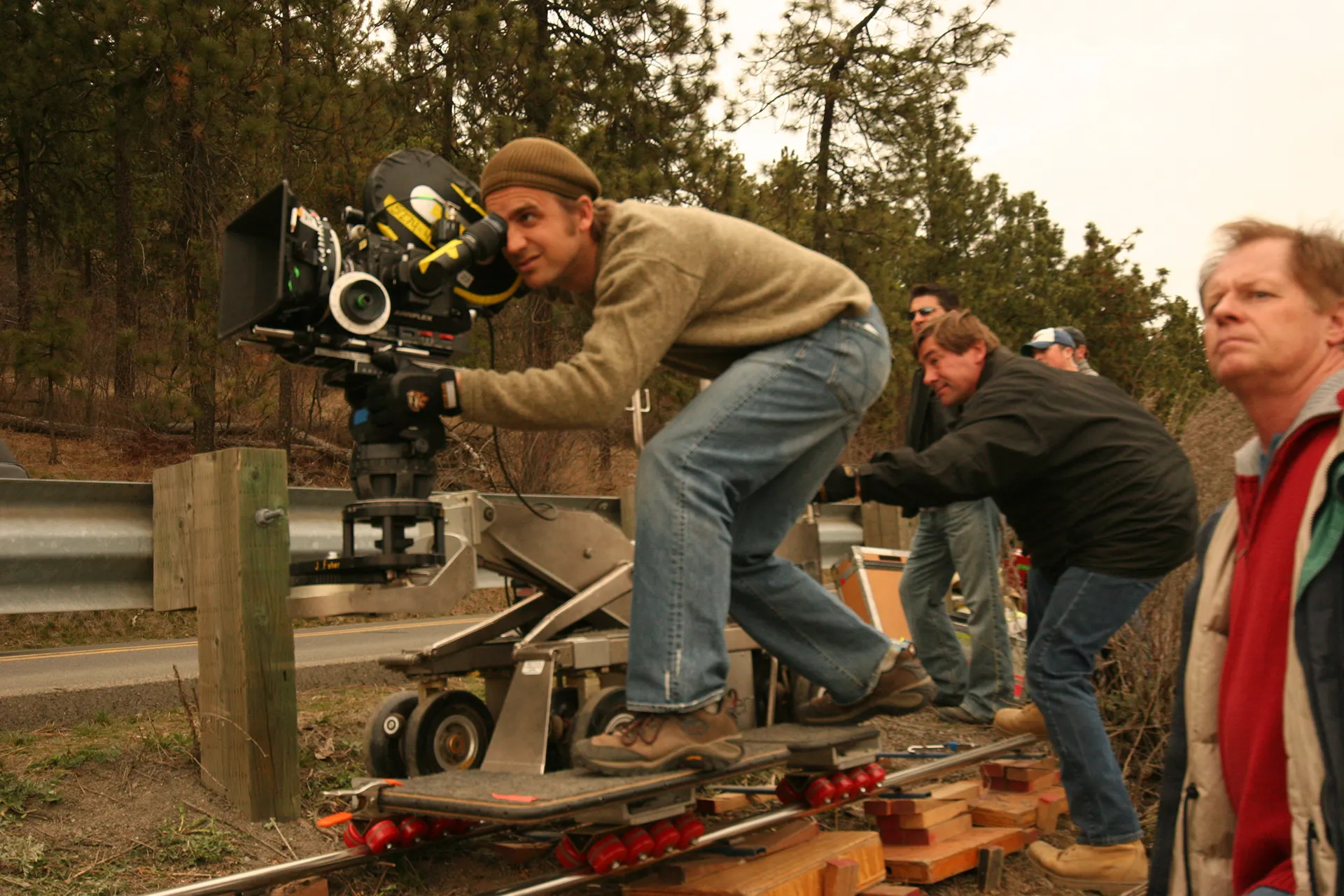 Douglas Cheney operating a camera on a dolly track during a shoot