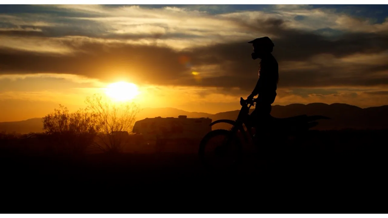 Silhouette of a rider against a desert sunset, from Douglas Cheney's documentary work