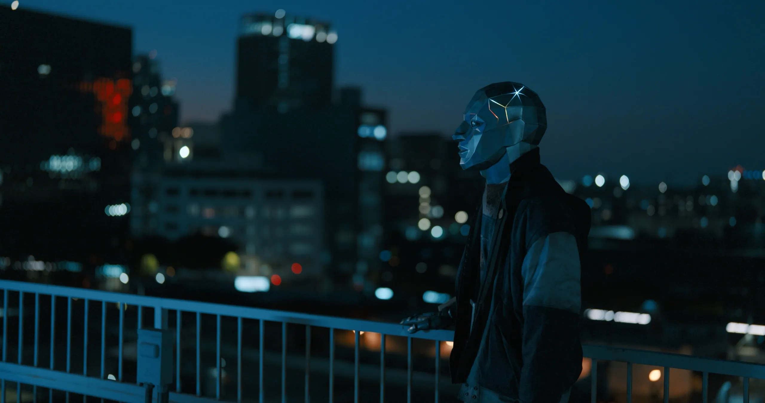 A figure in a mirrored mask on a rooftop above a city at night, from SIIGA